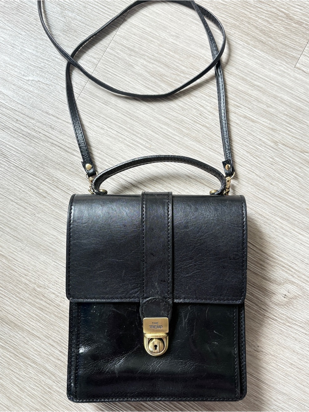 The Trend Black Leather Crossbody Messenger Bag with Top Handle and Gold Lock